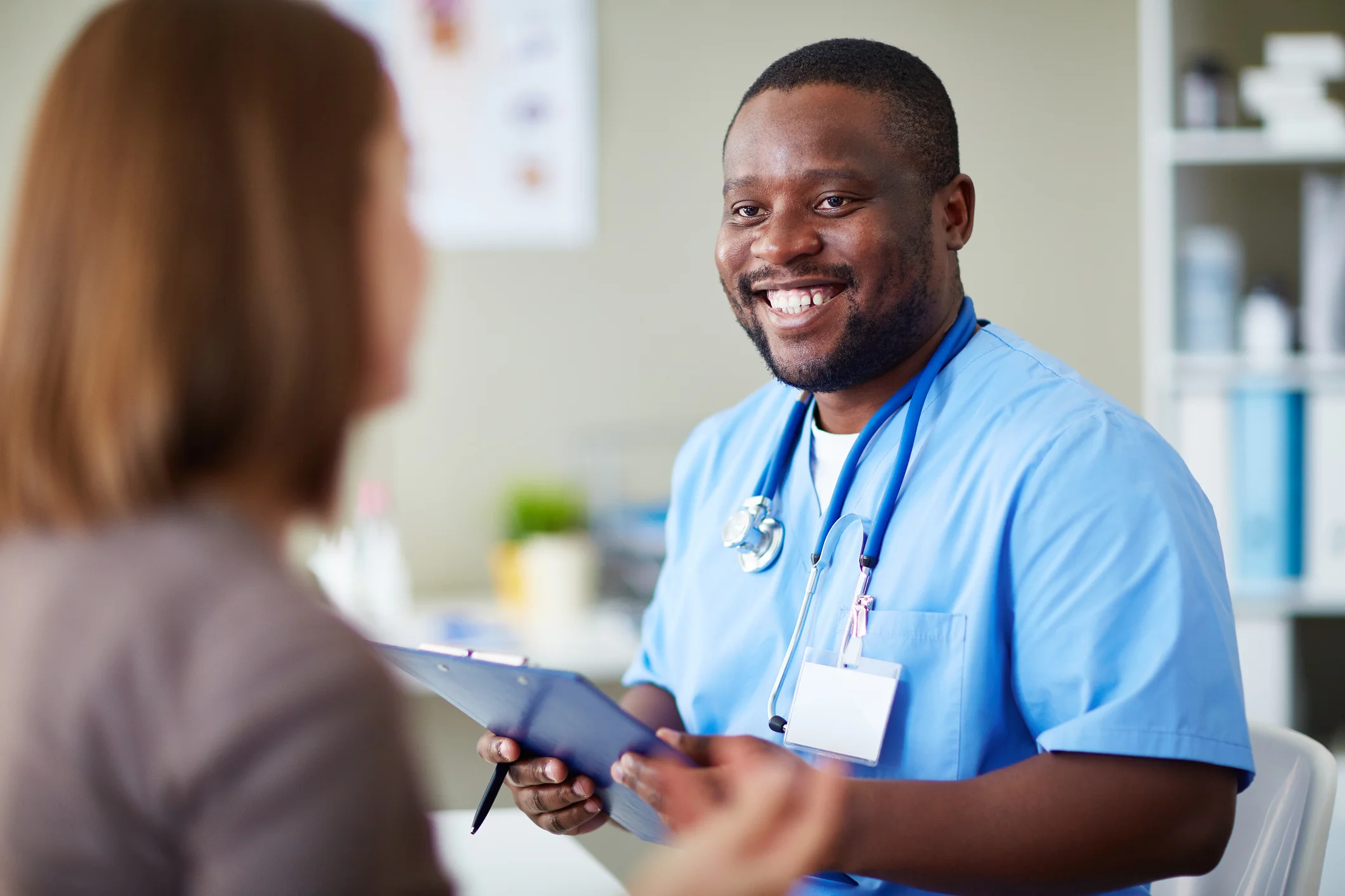a doctor showing a patient something on the tablet