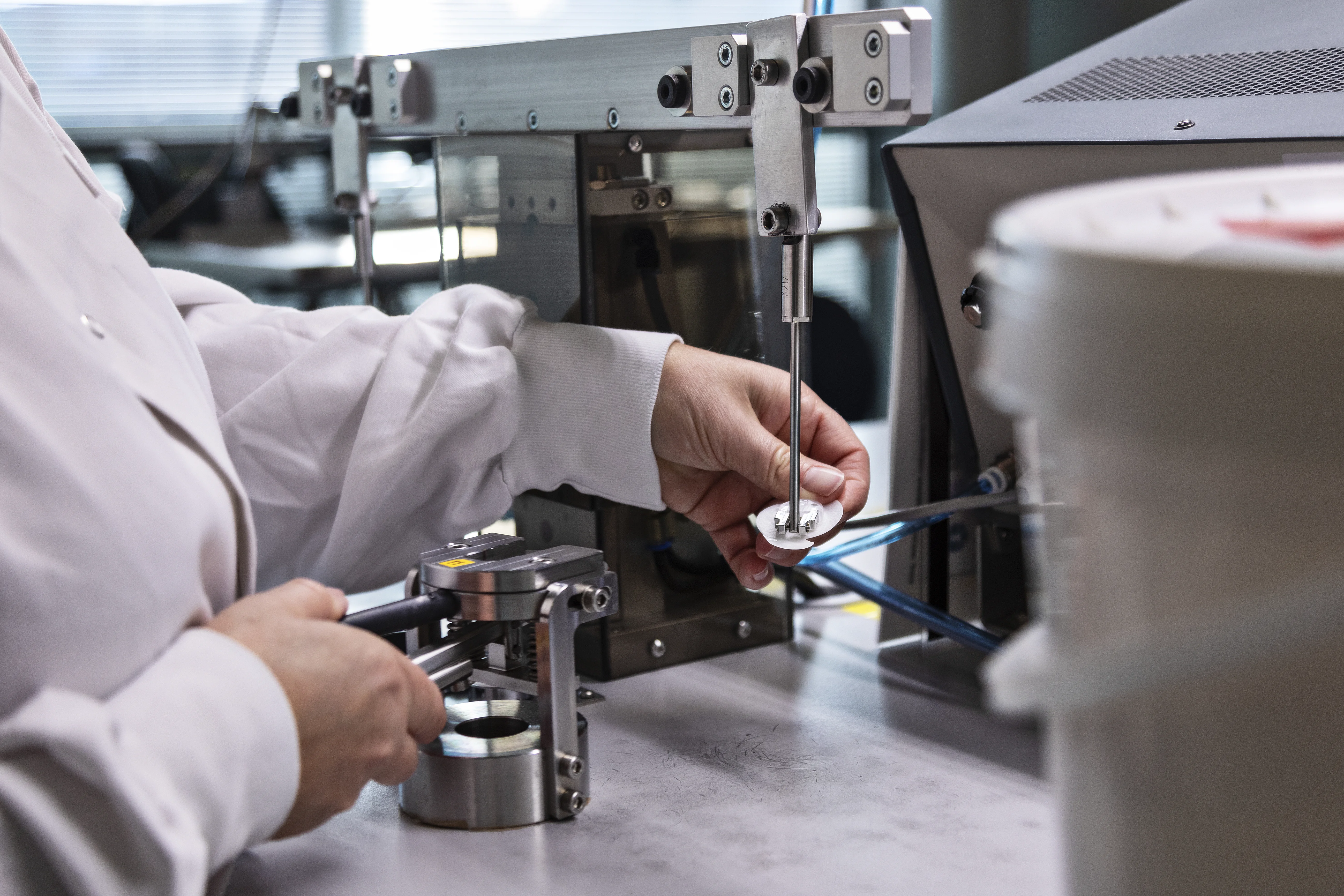 a person in a lab coat working on a machine