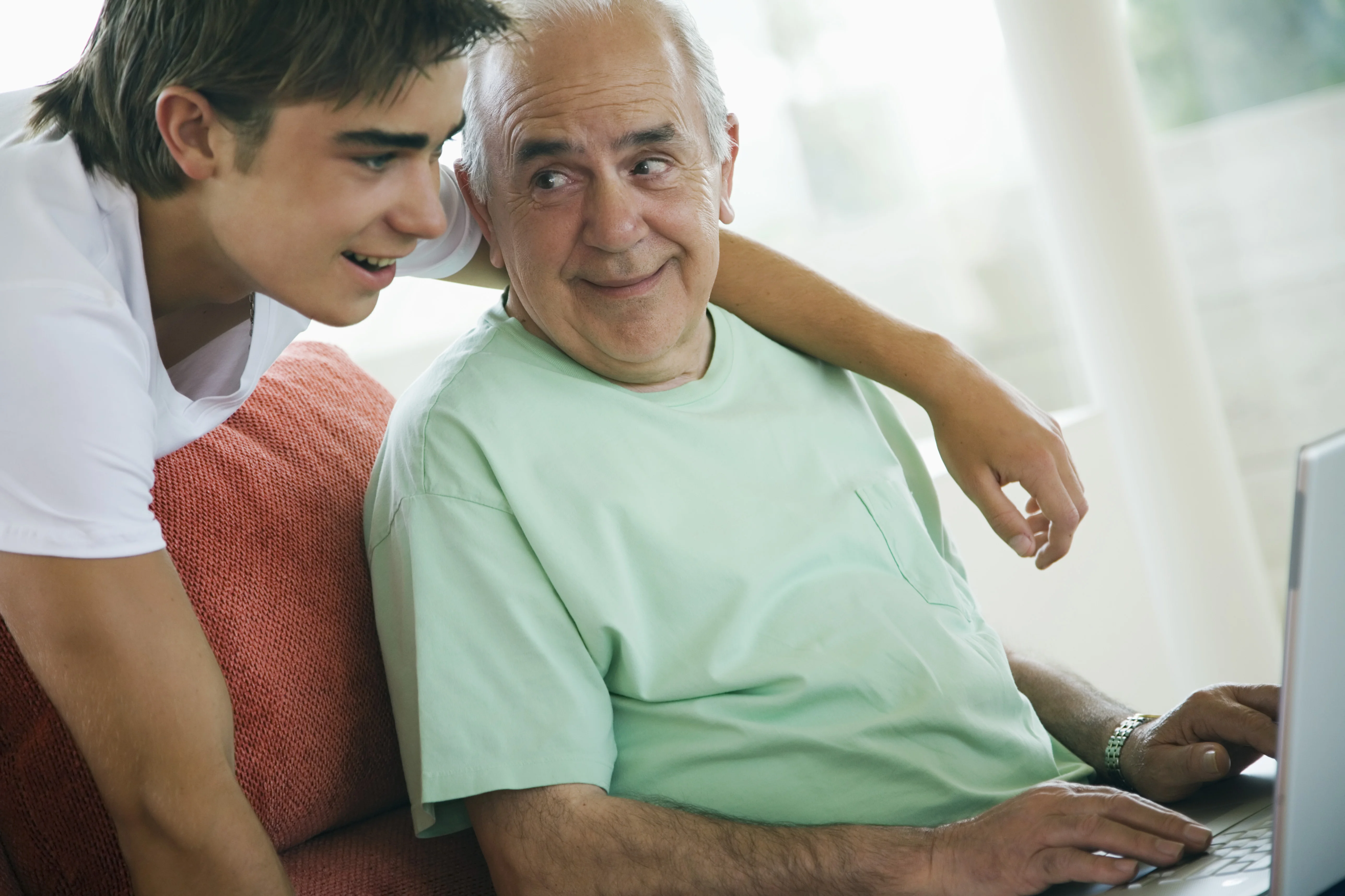 a man and a woman looking at a computer screen