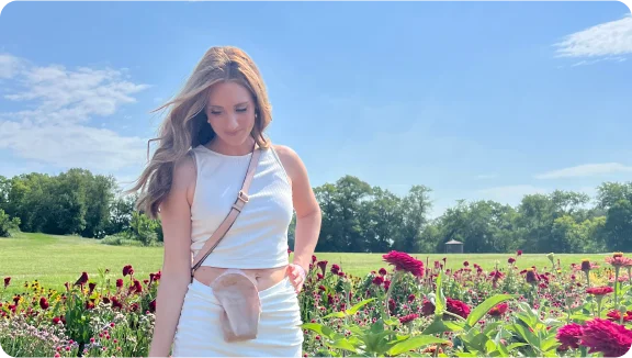 woman wearing ostomy pouch in a field 